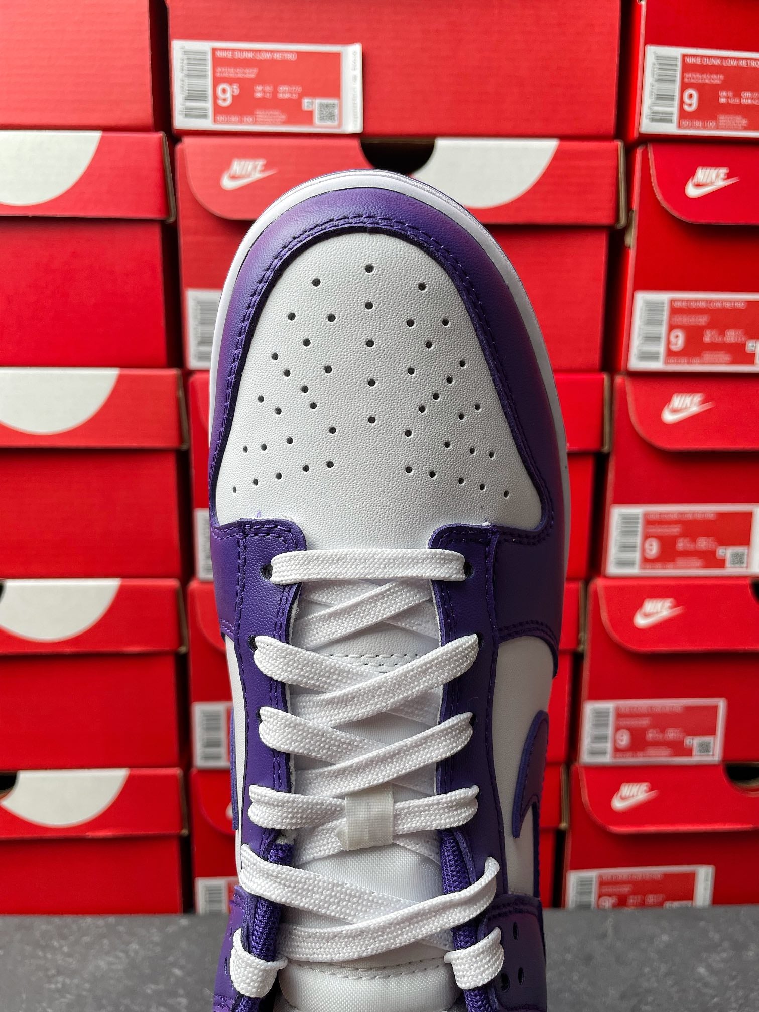 Nike Dunk Low sneaker toe view, perforated white toe box with purple upper