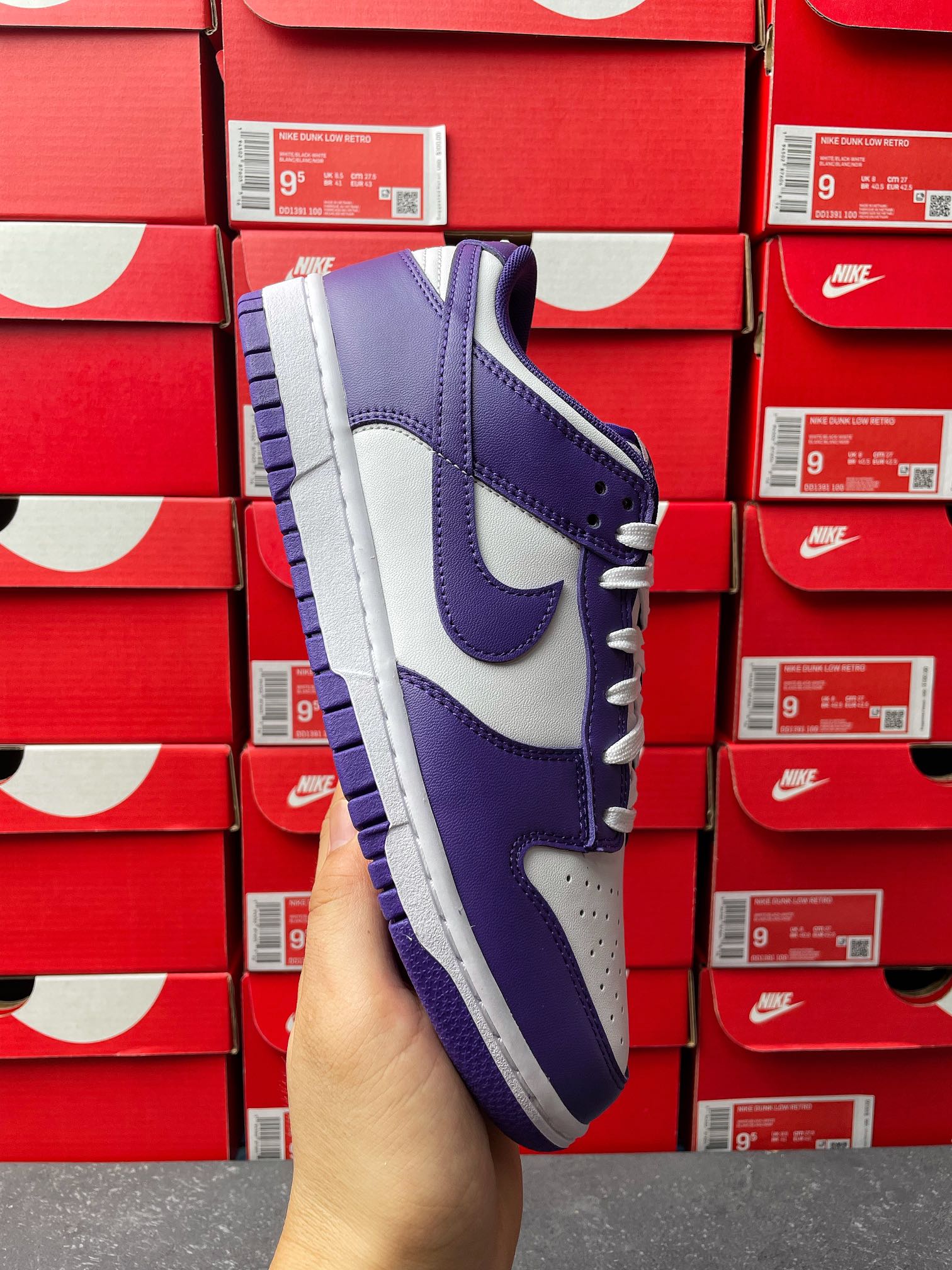 Nike Dunk Low sneaker side view, purple and white upper with lace-up detail