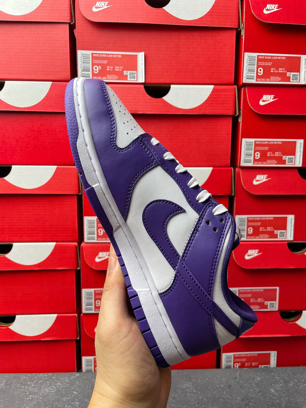 Nike Dunk Low sneaker front side view, purple and white upper with lace-up closure
