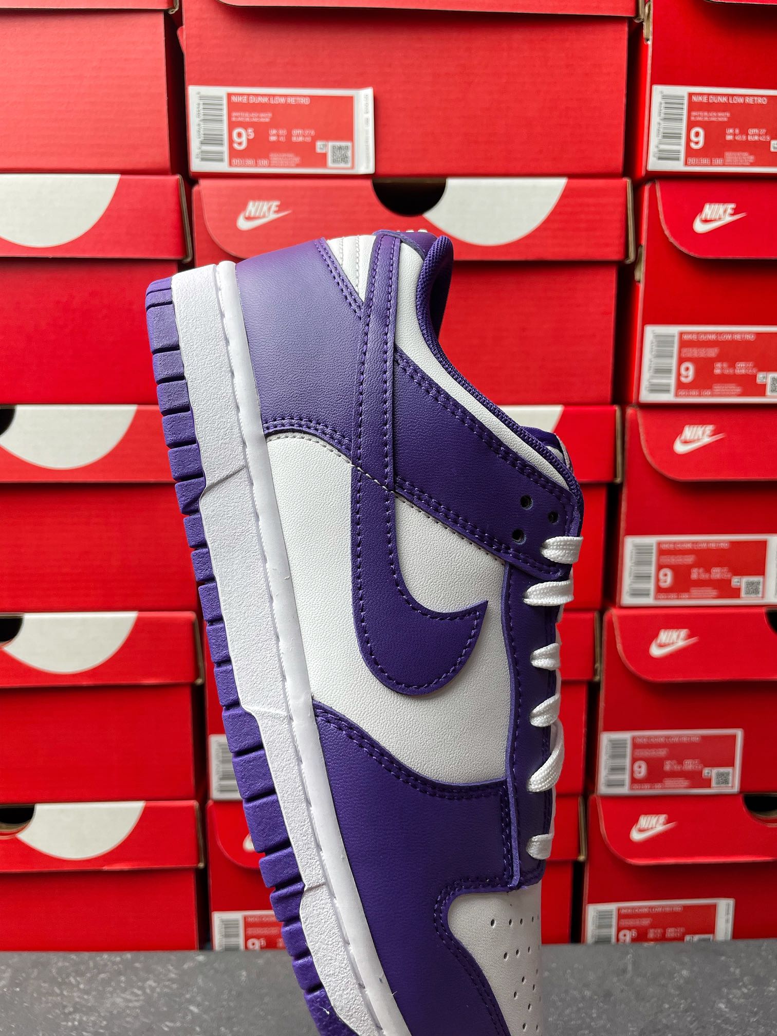 Nike Dunk Low sneaker in purple and white, lace-up with visible midsole and panels
