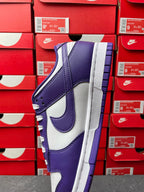 Nike Dunk Low sneaker, angled view with purple leather panels and white midsole