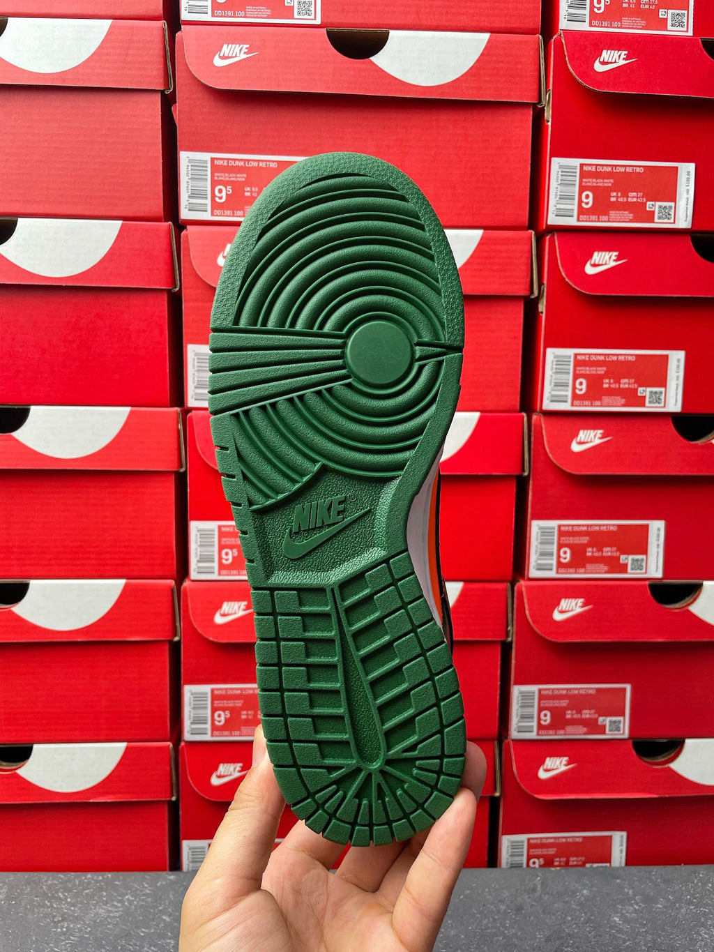 Green sneaker outsole with tread pattern and circular traction details.