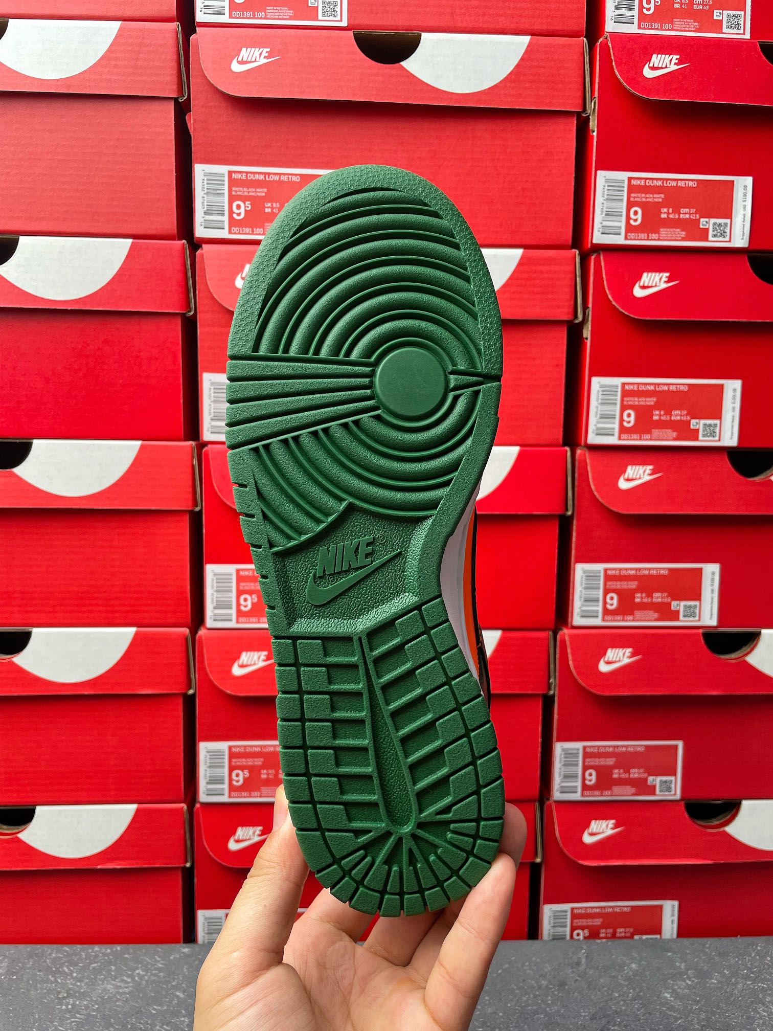 Green sneaker outsole with tread pattern and circular traction details.