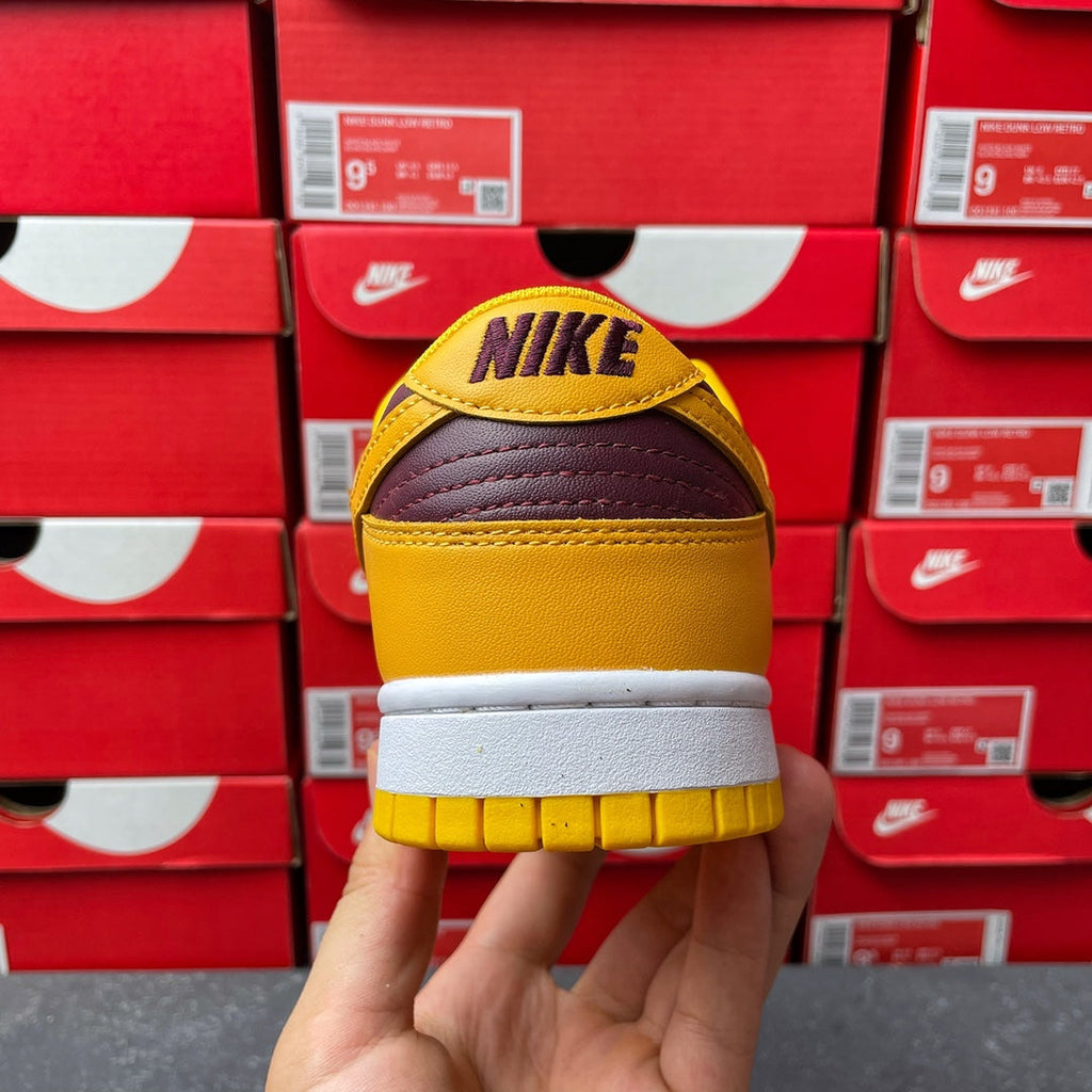 Nike Dunk Low heel with NIKE logo on purple-and-yellow back panel and white midsole