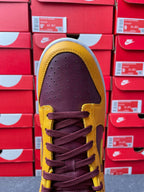 Nike Dunk Low top view with purple laces, dark purple toe box, and yellow trim