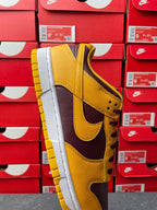 Nike Dunk Low sneaker front-side view with yellow leather and dark purple panels