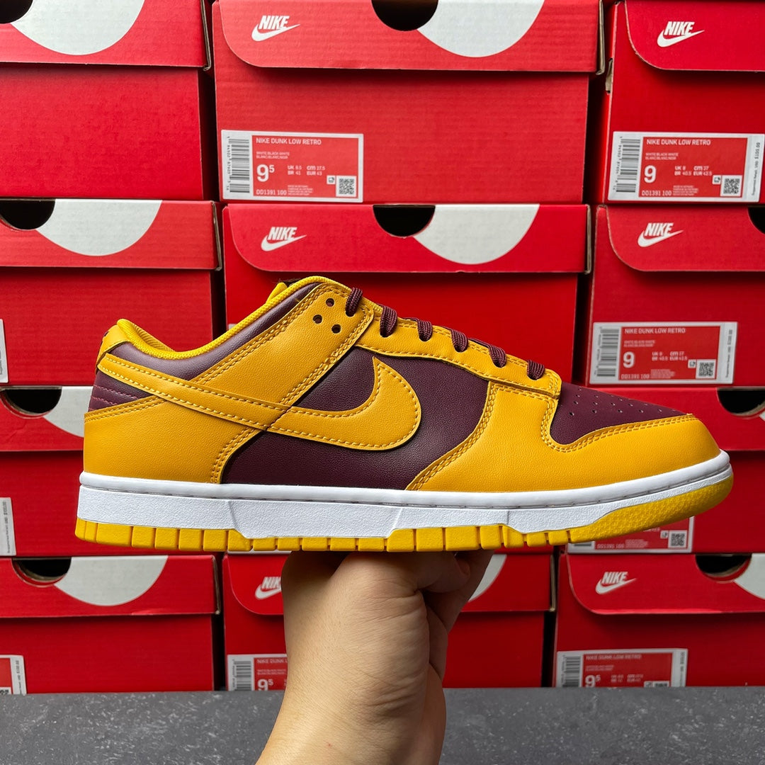 Nike Dunk Low sneaker in yellow leather with dark purple overlays and white sole