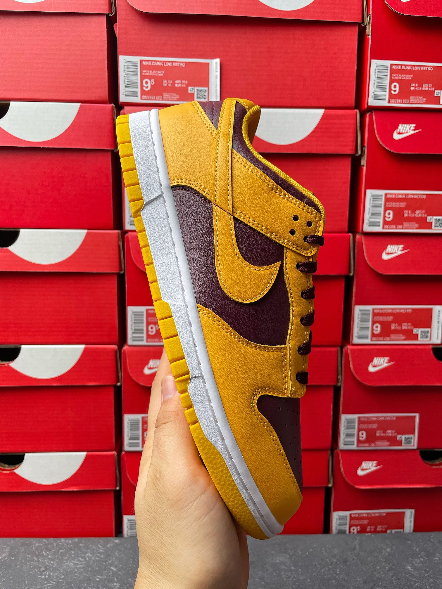 Nike Dunk Low side view, yellow upper with dark purple swoosh and white sole
