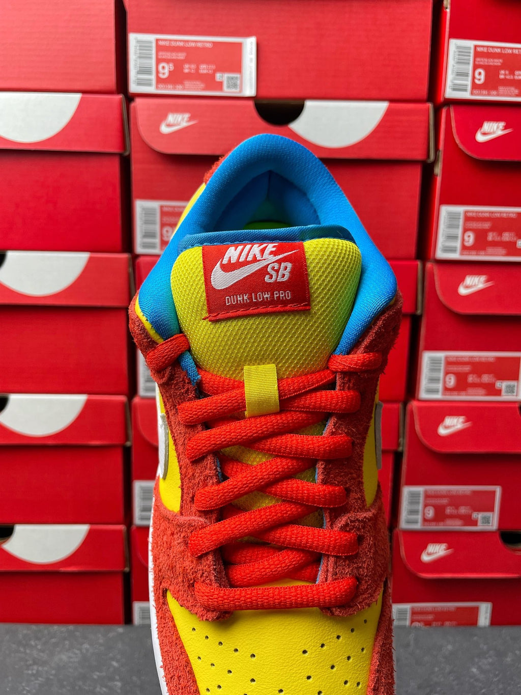 Nike Dunk Low sneaker, heel and tongue view with NIKE SB text, red laces