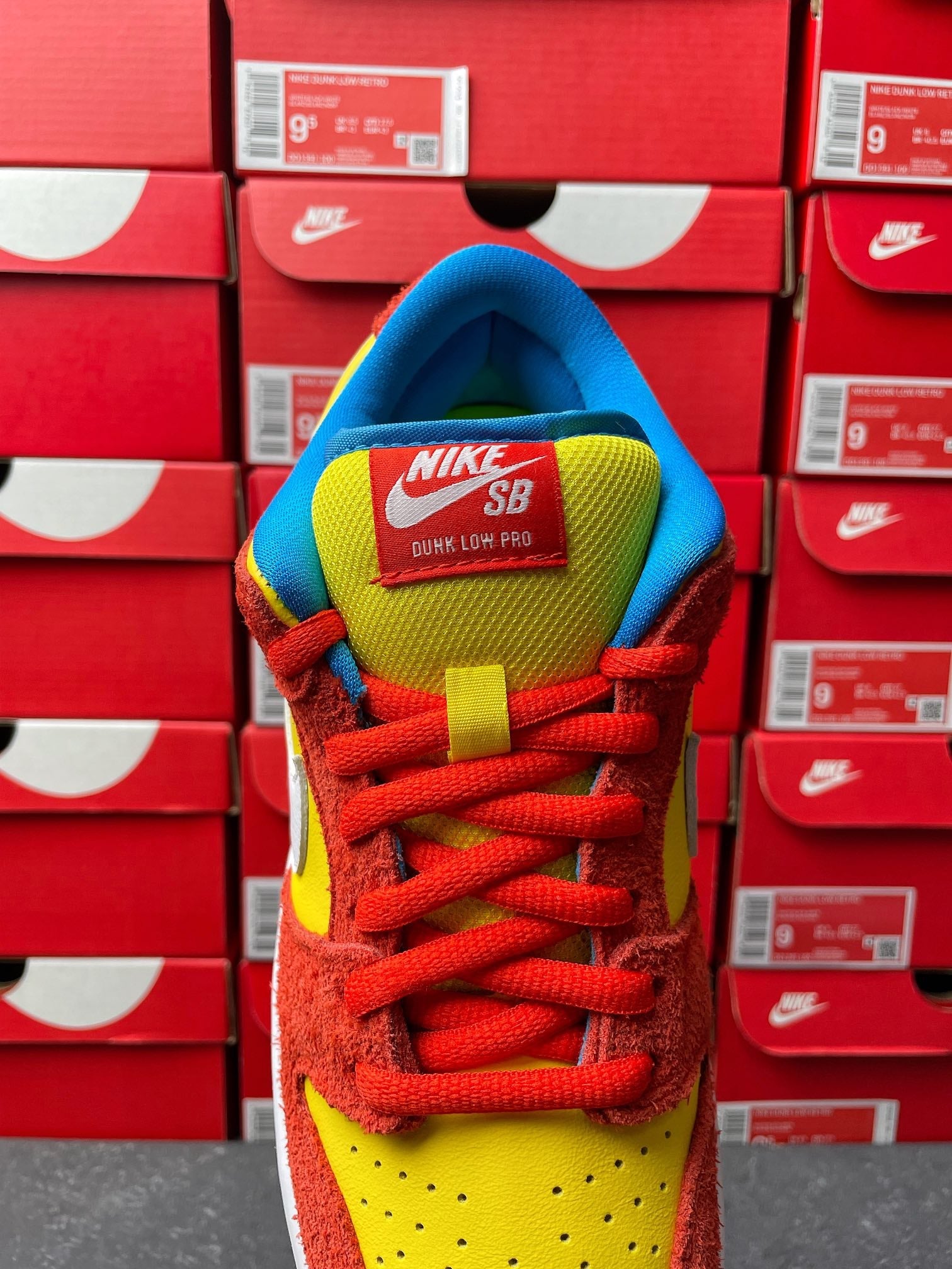 Nike Dunk Low sneaker, heel and tongue view with NIKE SB text, red laces