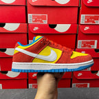 Nike Dunk Low sneaker, red suede with yellow swoosh and blue outsole, side view