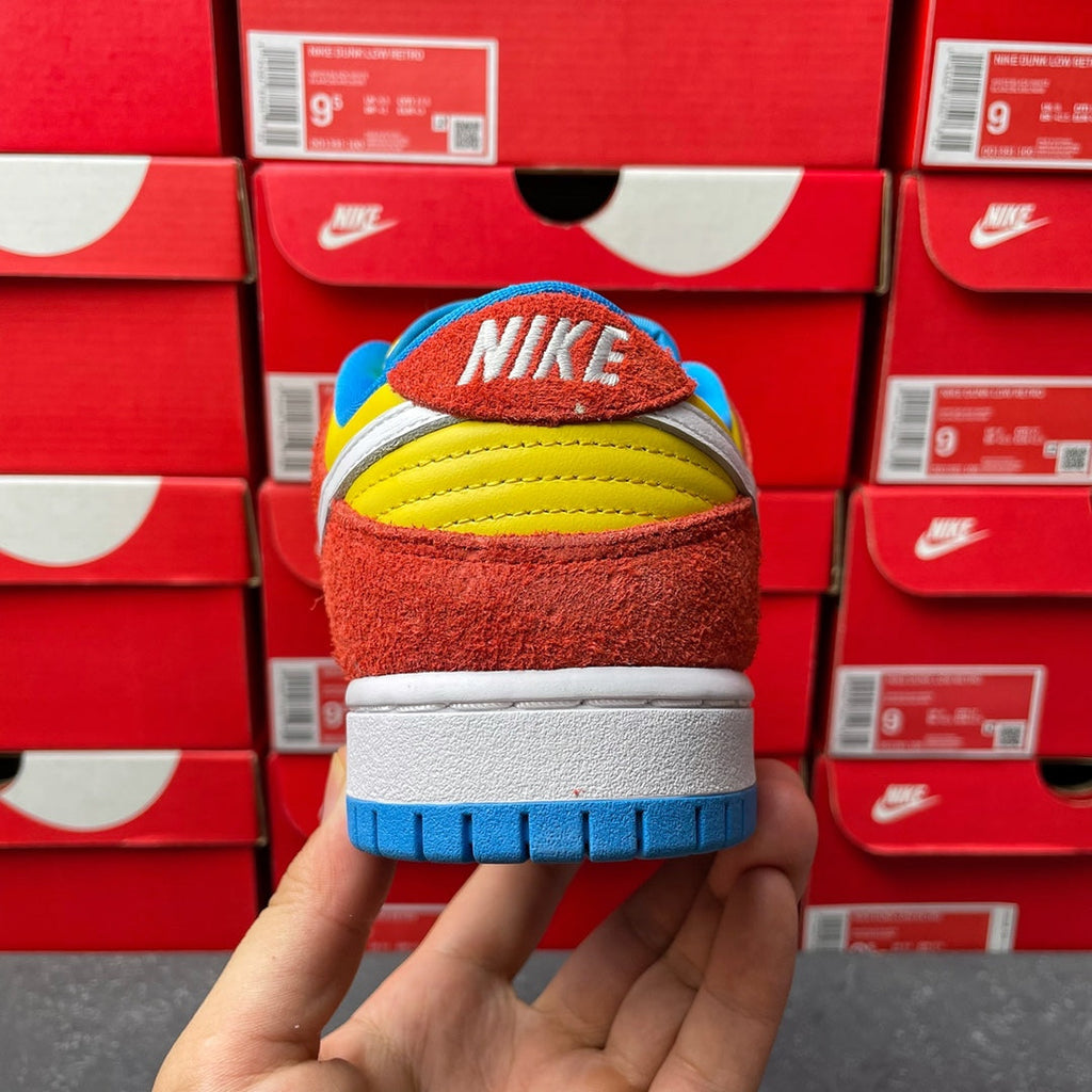 Nike Dunk Low sneaker, back heel view with NIKE text on blue collar and red suede
