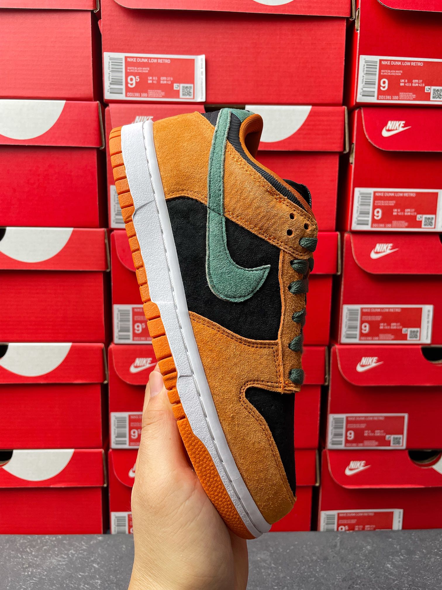 Nike Dunk Low skate shoe in orange, teal, and black with white midsole and orange tread
