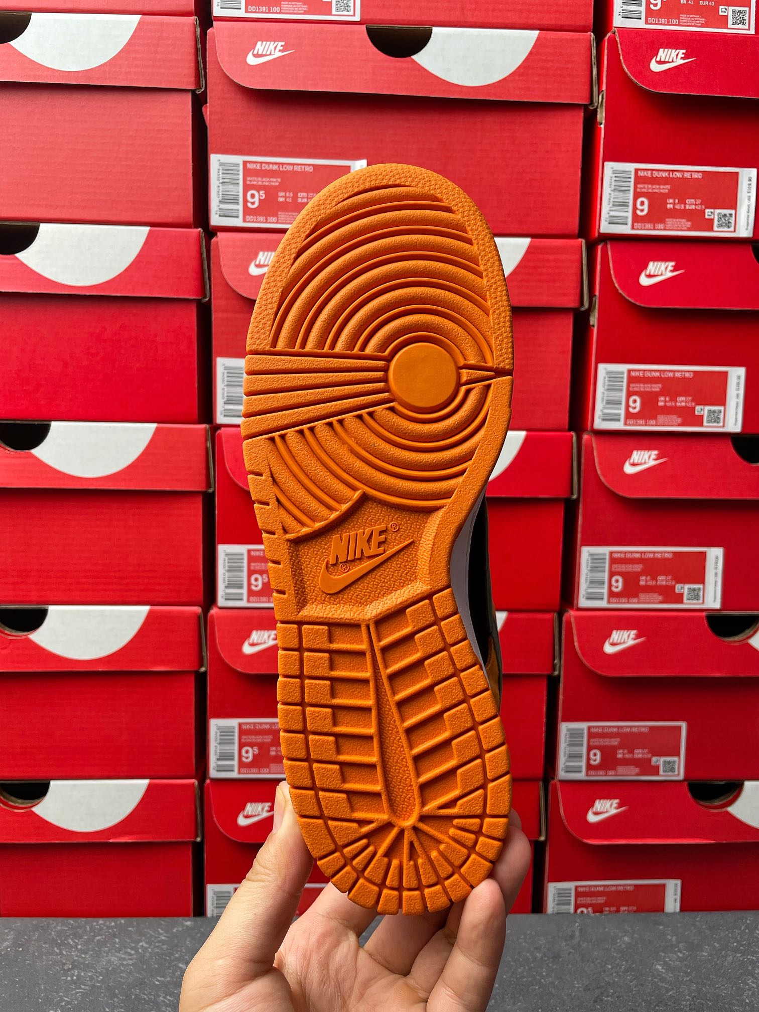 Nike Dunk Low outsole view with orange rubber tread pattern