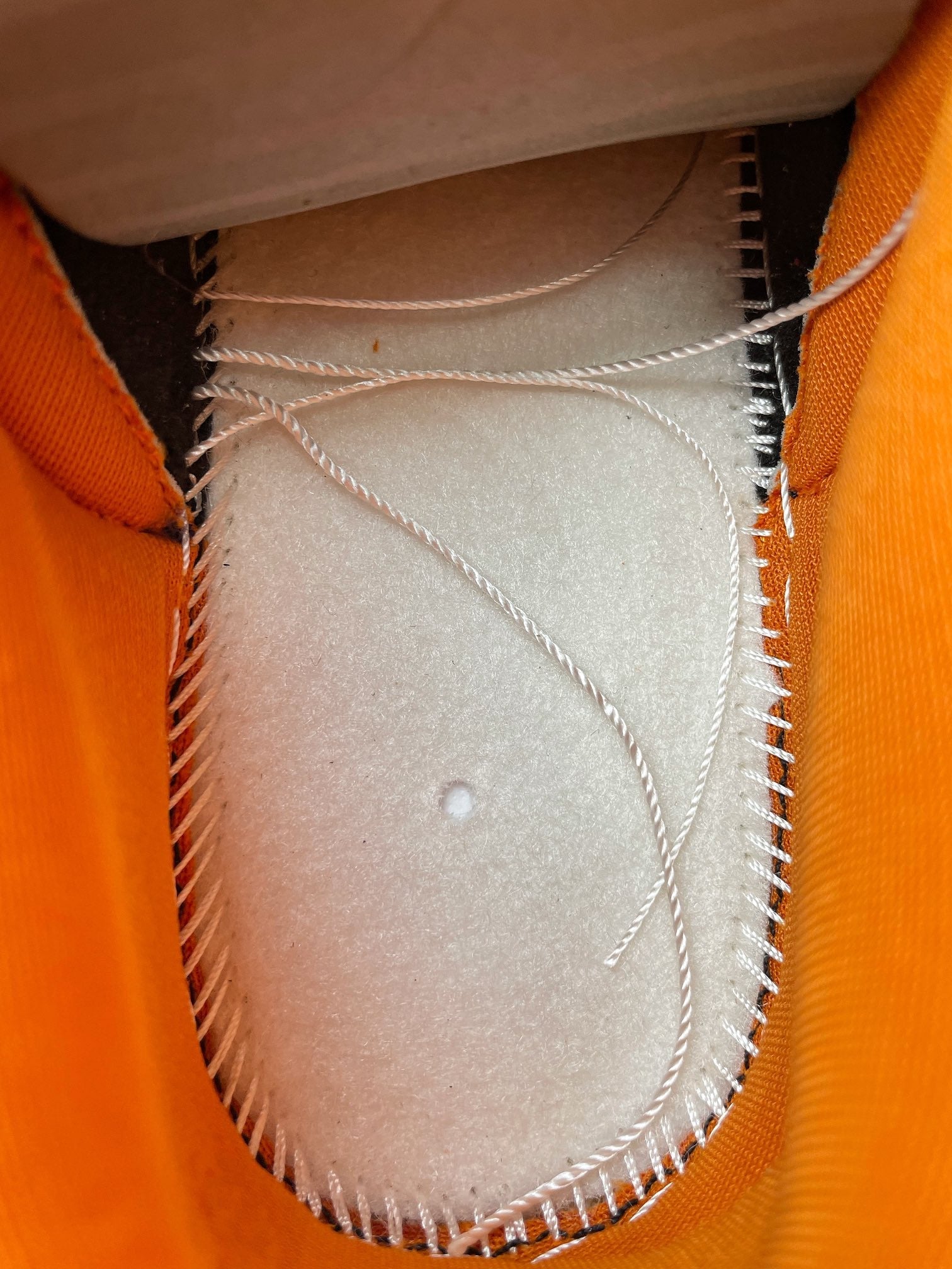 Nike Dunk Low inner lining with white fabric and stitched edge at the toe area