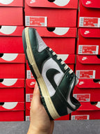 Nike Dunk Low sneaker angled view with dark green upper and white Swoosh