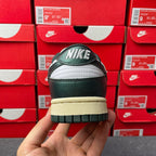Nike Dunk Low sneaker back view with NIKE logo on green leather heel