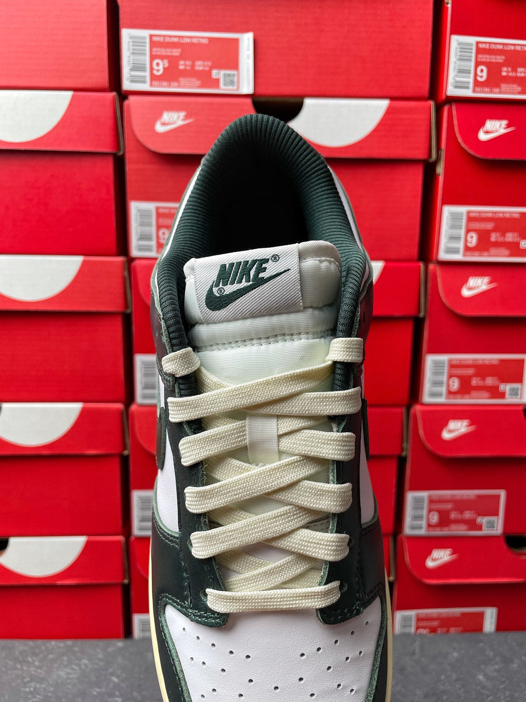 Nike Dunk Low sneaker heel view with NIKE branding and beige lace-up accents