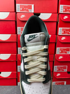 Nike Dunk Low sneaker heel view with NIKE branding and beige lace-up accents