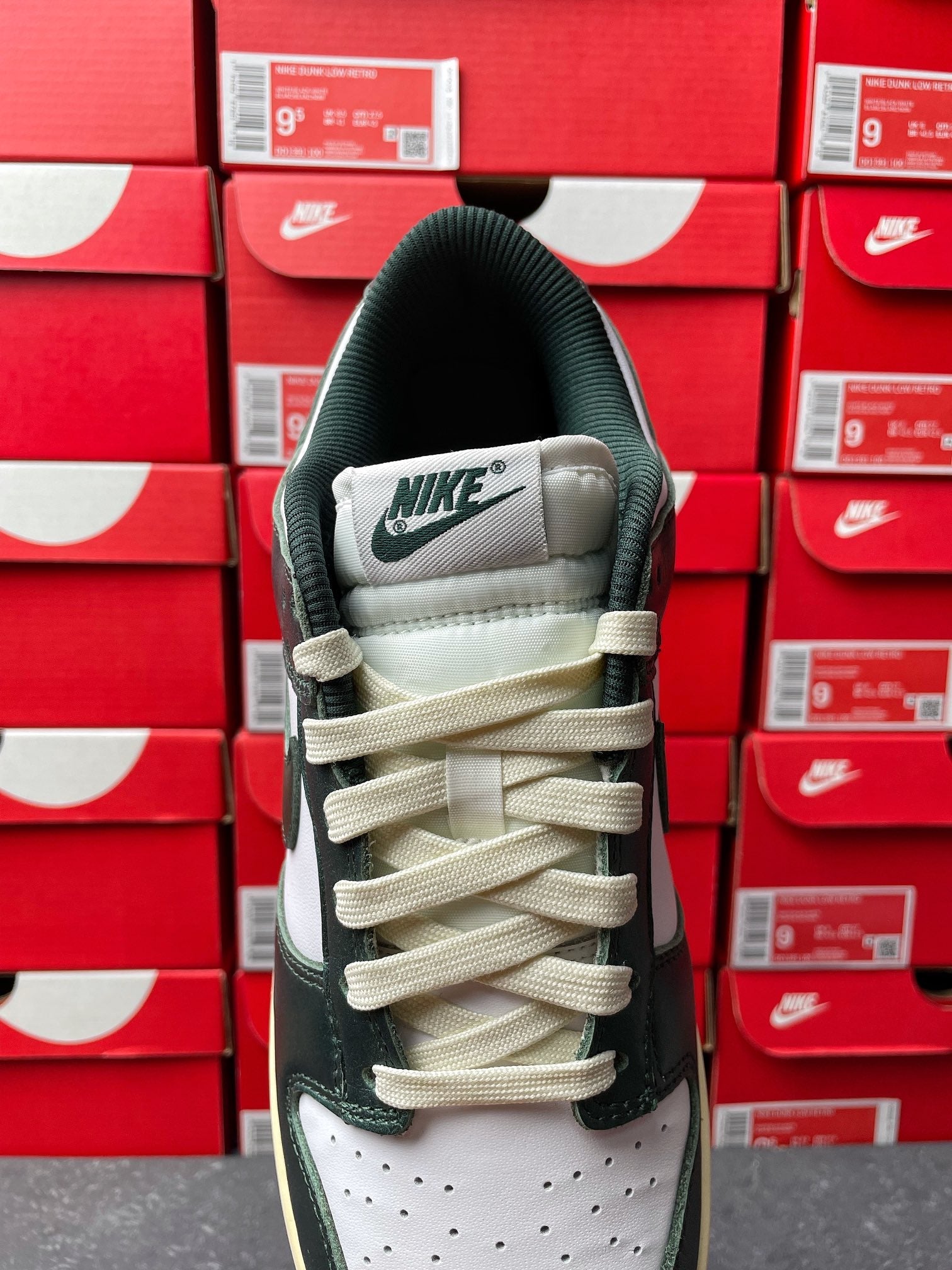 Nike Dunk Low sneaker heel view with NIKE branding and beige lace-up accents