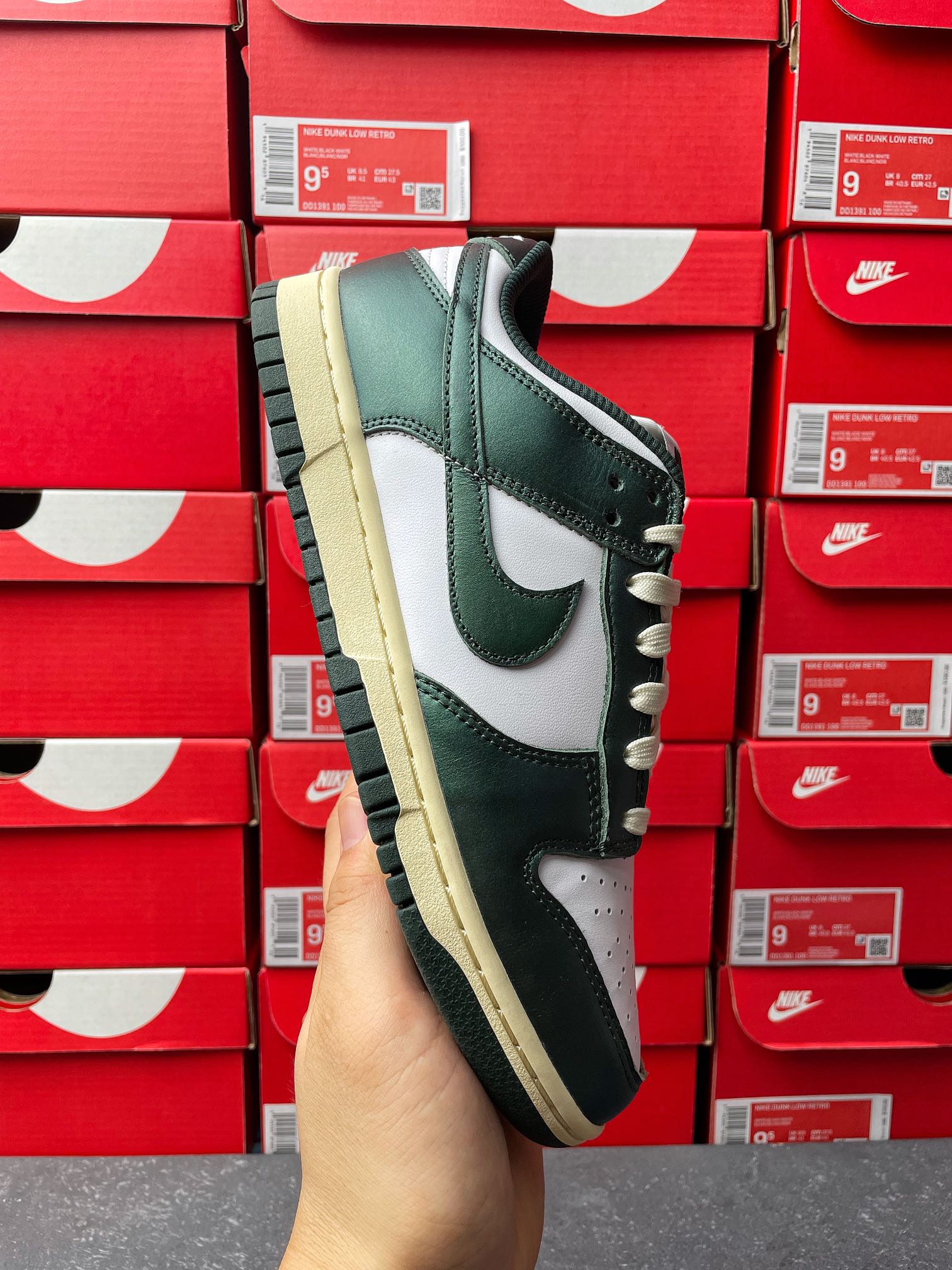 Nike Dunk Low side view sneaker in dark green and white with cream outsole