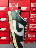 Nike Dunk Low sneaker front-side view, dark green upper with white Swoosh