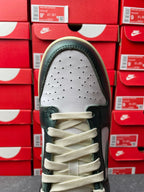 Nike Dunk Low toe view with perforated white panel and dark green leather