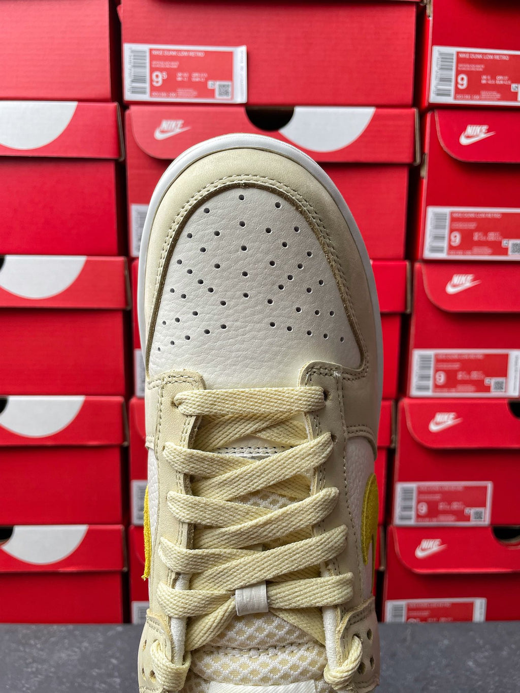 Nike Dunk Low sneaker, toe view; cream leather with perforations and lace-up front