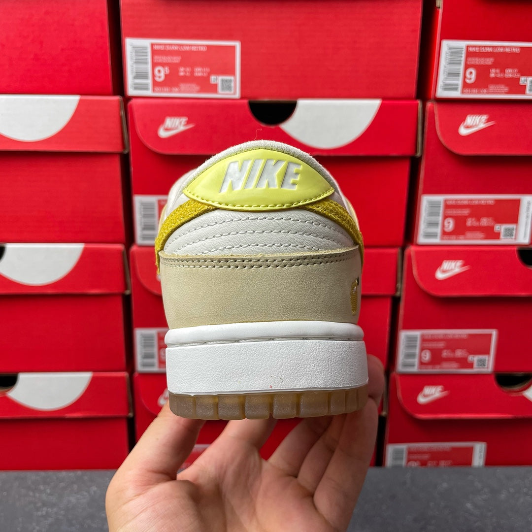 Nike Dunk Low sneaker, heel view; cream suede with lemon-yellow Nike logo