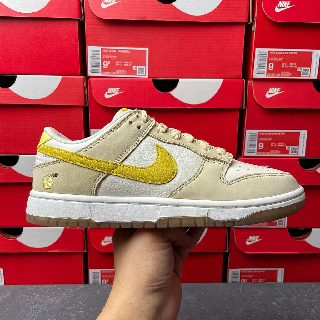 Nike Dunk Low sneaker, cream leather with lemon-yellow swoosh and laces