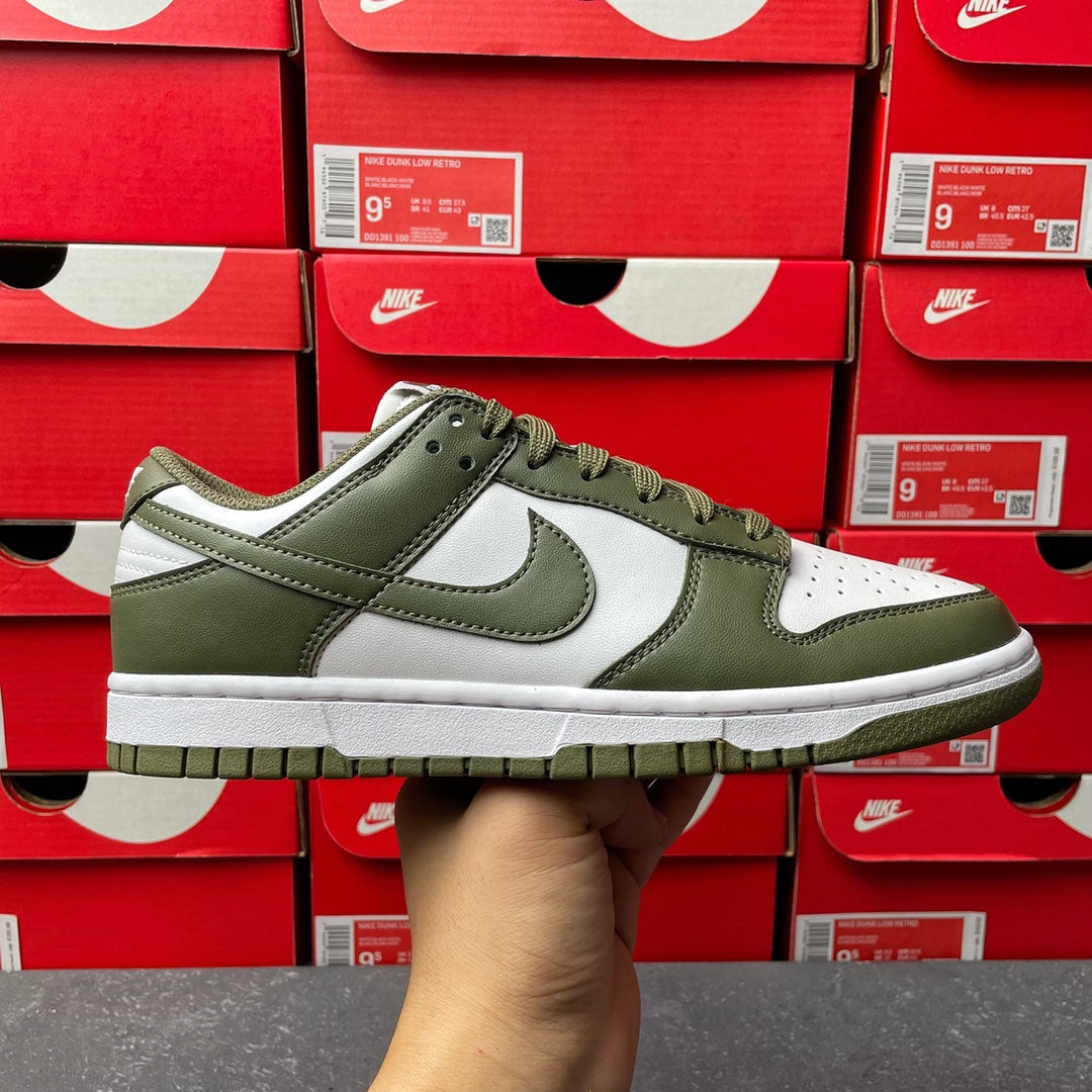 Low-top sneaker with white leather panels and olive green overlays, lace-up front.