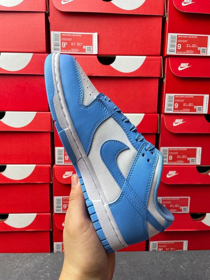 Blue and white Nike Dunk Low sneakers with suede panels and gray rubber sole