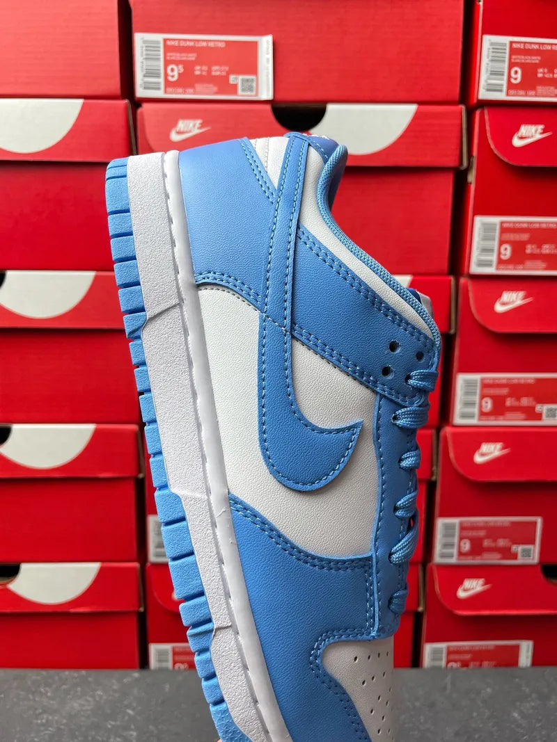 Blue and white Nike Dunk Low sneakers, quarter side view with stitched swoosh