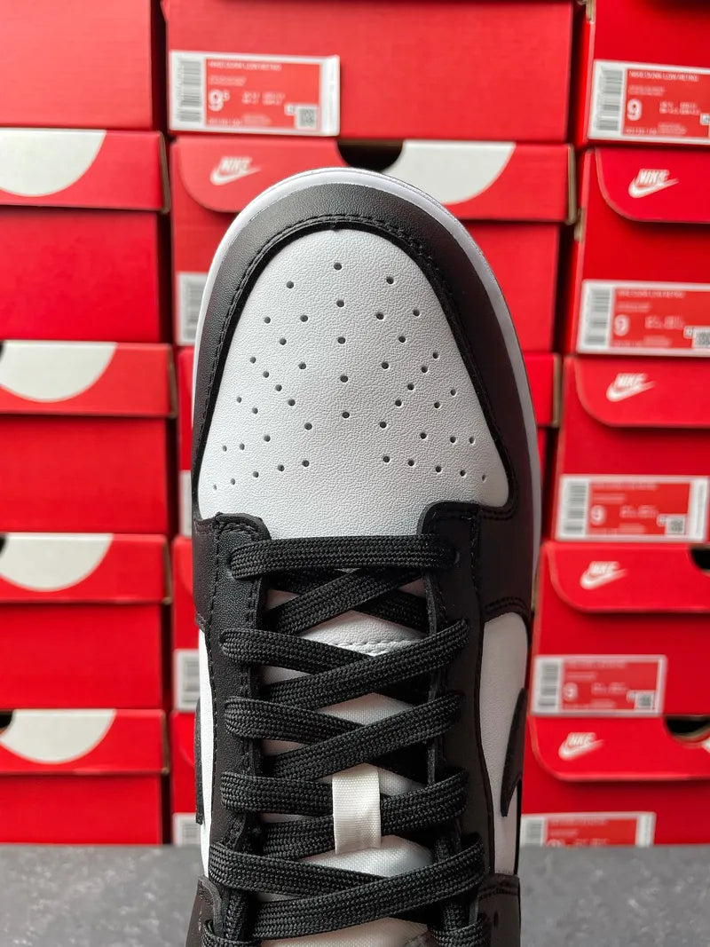 Nike Dunk Low Panda sneaker toe box view, perforated white leather with black laces