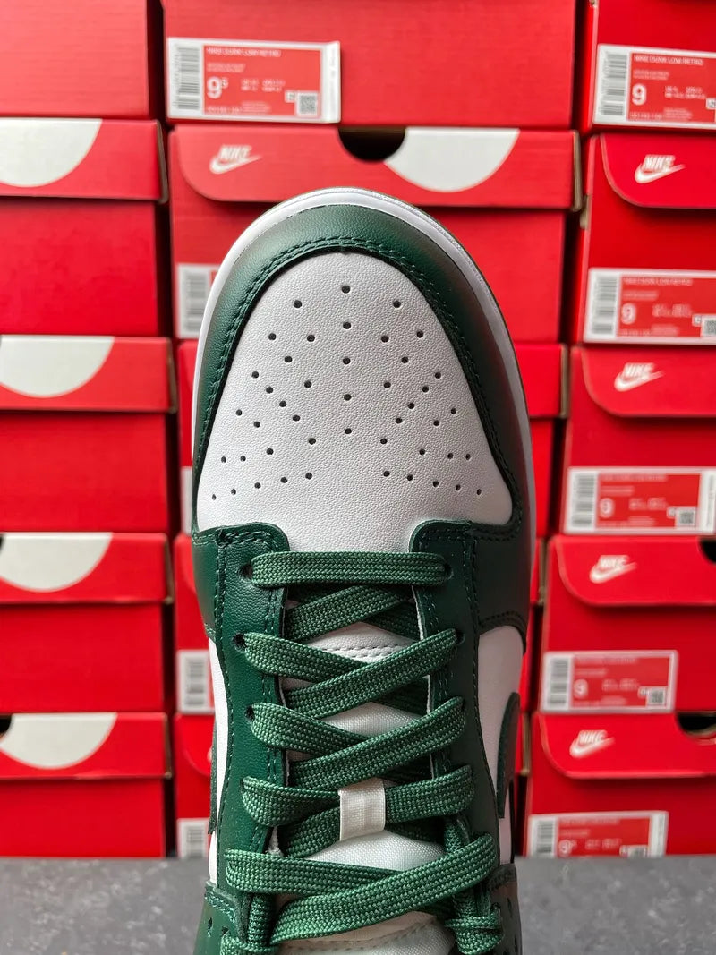 Nike Dunk Low toe cap view with perforated white panel and dark green lace-up