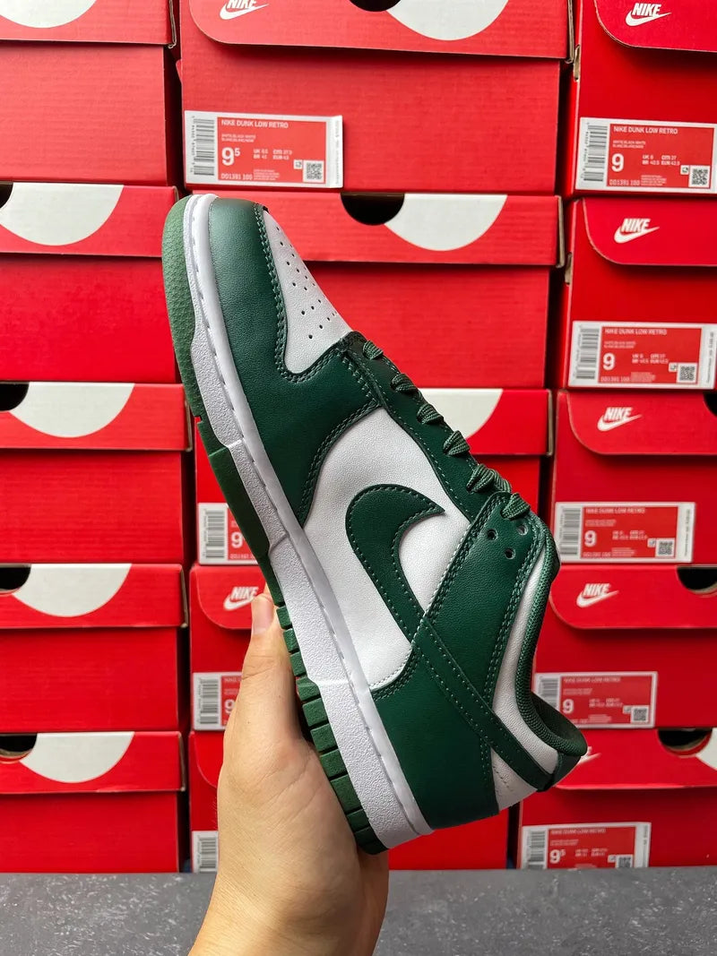 Nike Dunk Low sneaker angled side view showing dark green overlays and white midsole