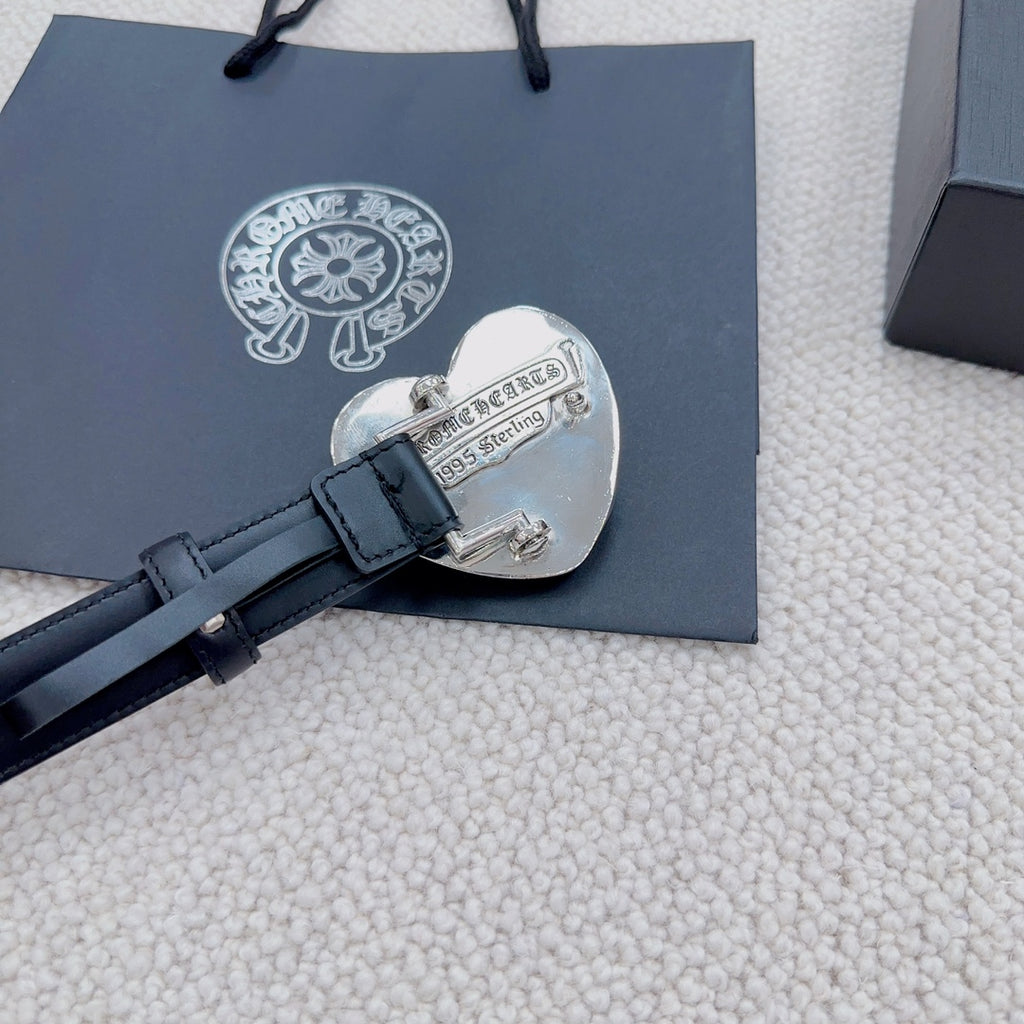 Heart-shaped silver buckle on dark blue leather belt with engraved text
