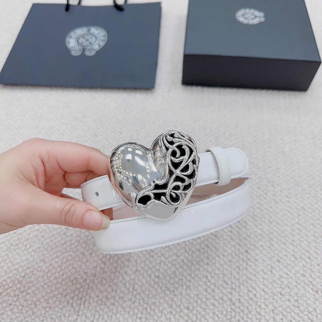 White belt with silver heart buckle close-up, held at the strap end