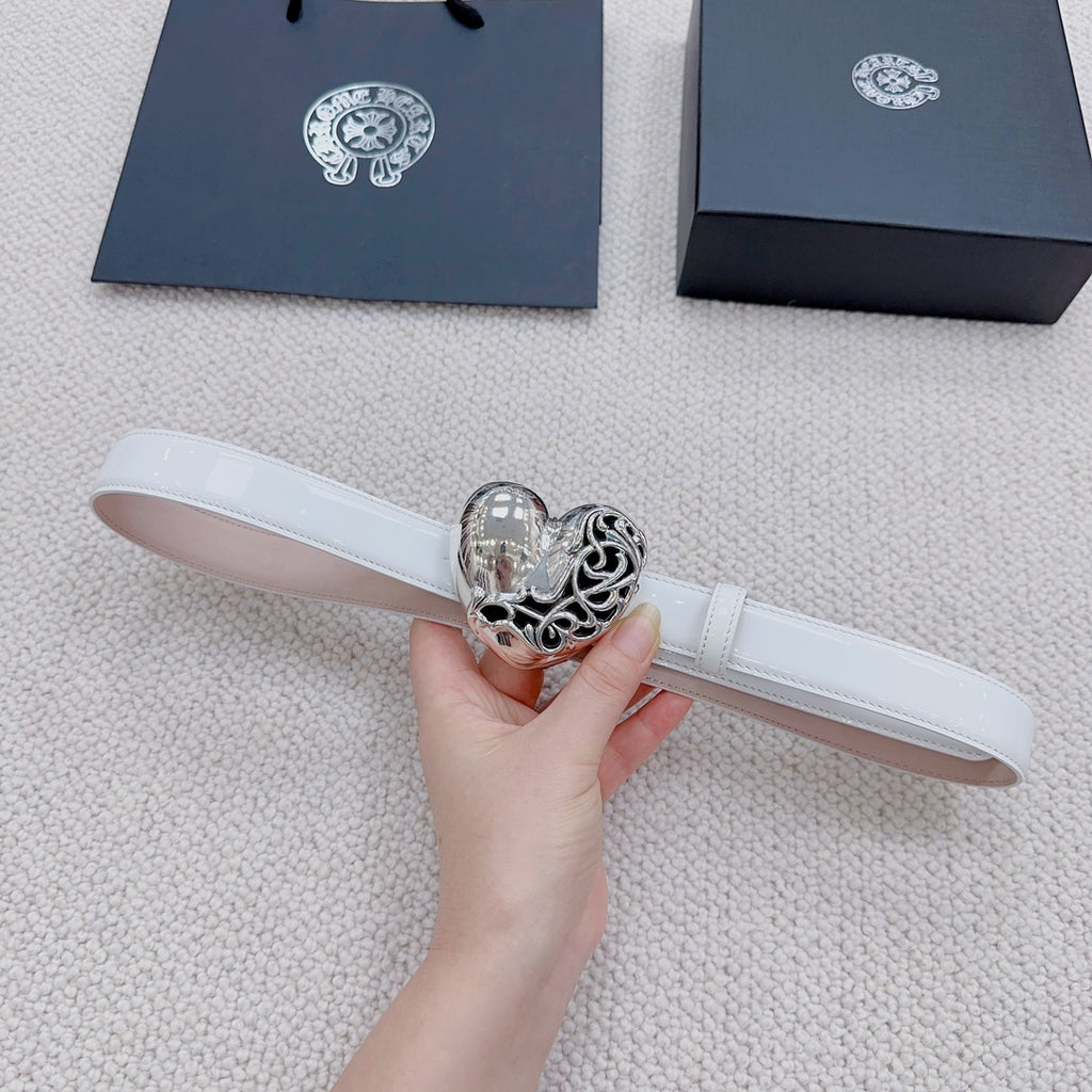 White leather belt with silver heart center buckle, held in hand