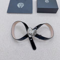 Chrome belt with glossy black strap and silver heart buckle with decorative scrollwork.