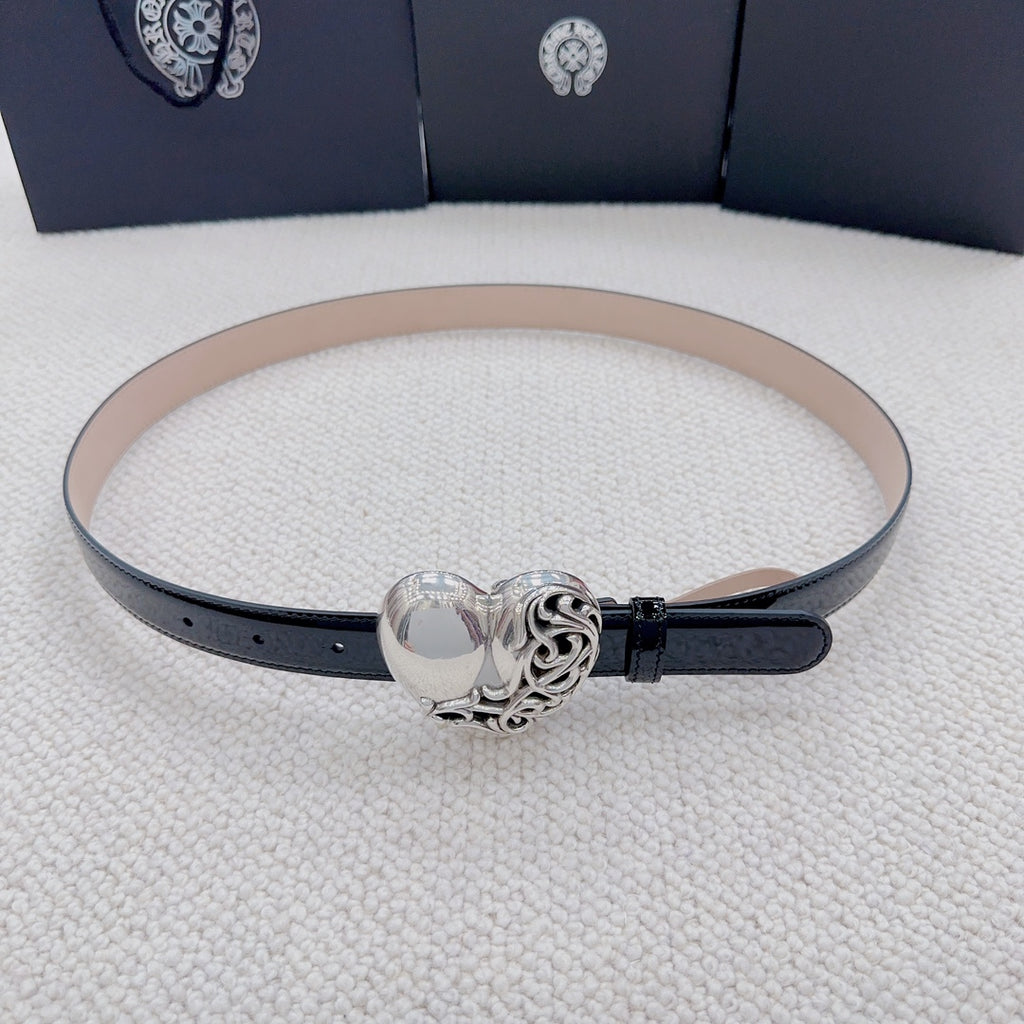 Chrome belt with black outer strap, tan lining, and centered silver heart buckle clasp.