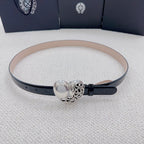 Chrome belt with black outer strap, tan lining, and centered silver heart buckle clasp.