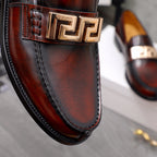 Versace leather loafer close-up, dark brown with gold buckle and stitched trim