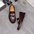 Versace leather loafers, dark brown slip-on style with gold buckle and black soles