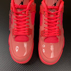 Pink Air Jordan 4 sneaker pair with red laces and mesh tongue detail