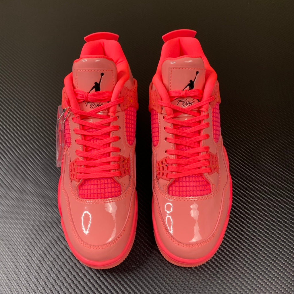 Pink Air Jordan 4 sneaker pair front view with red laces and glossy uppers