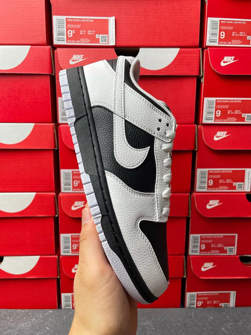 Nike Dunk Low low-top sneakers, white leather upper with black swoosh and white laces