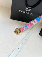 Blue and pink patterned belt with gold buckle and white leather strap, side view
