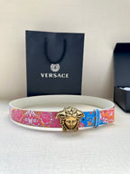 White belt with blue and pink patterned strap and gold Medusa-head buckle