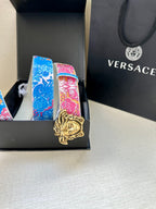 Blue and pink patterned belt with gold lion-head buckle